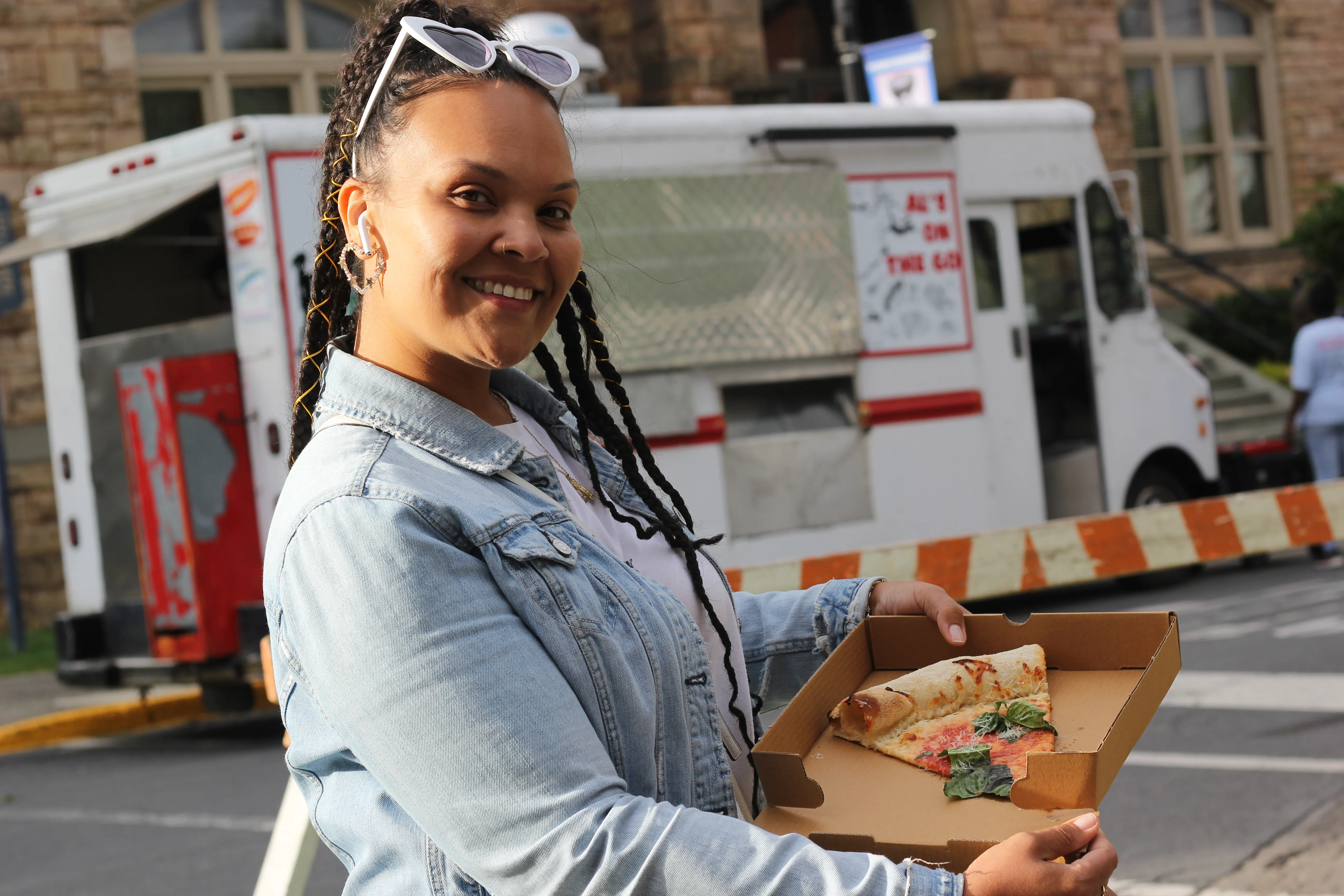 Woman-Holding-A-Slice-Of-Pizza